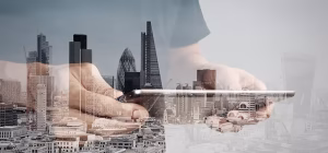 A city skyline blended with a hand holding a tablet
