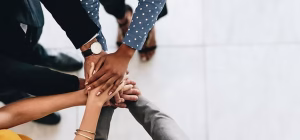 A team stacking hands together