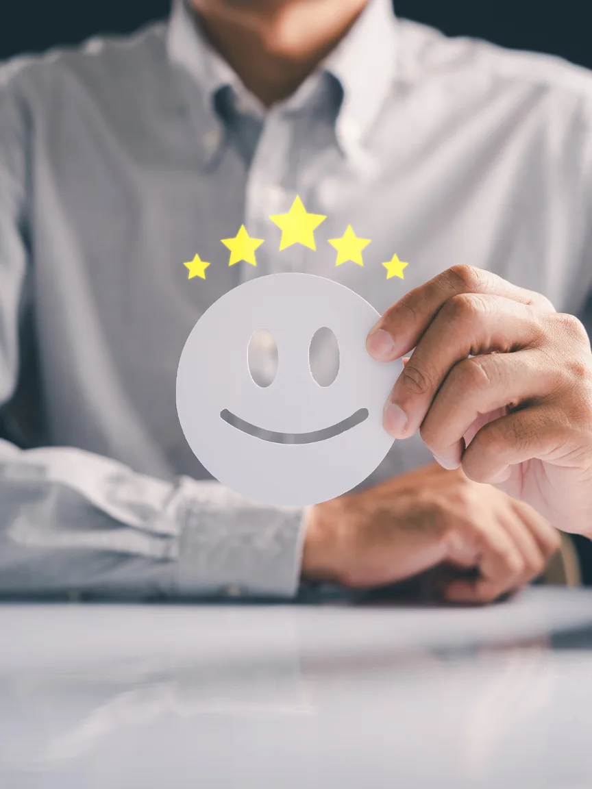 A person holding a customer satisfaction rating card